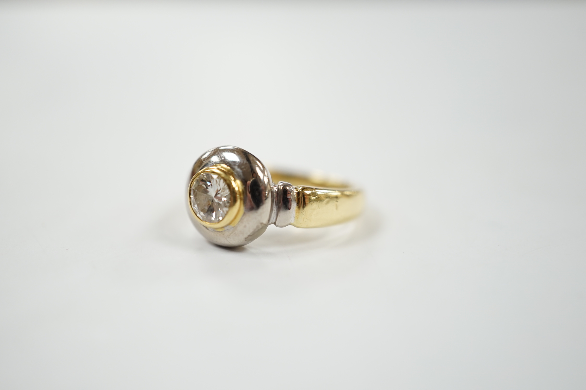A modern 18ct gold and collet set solitaire diamond ring, with engraving to commemorate the Millenium Dome, the stone weighing 0.40ct, size J, gross weight 6.7 grams.